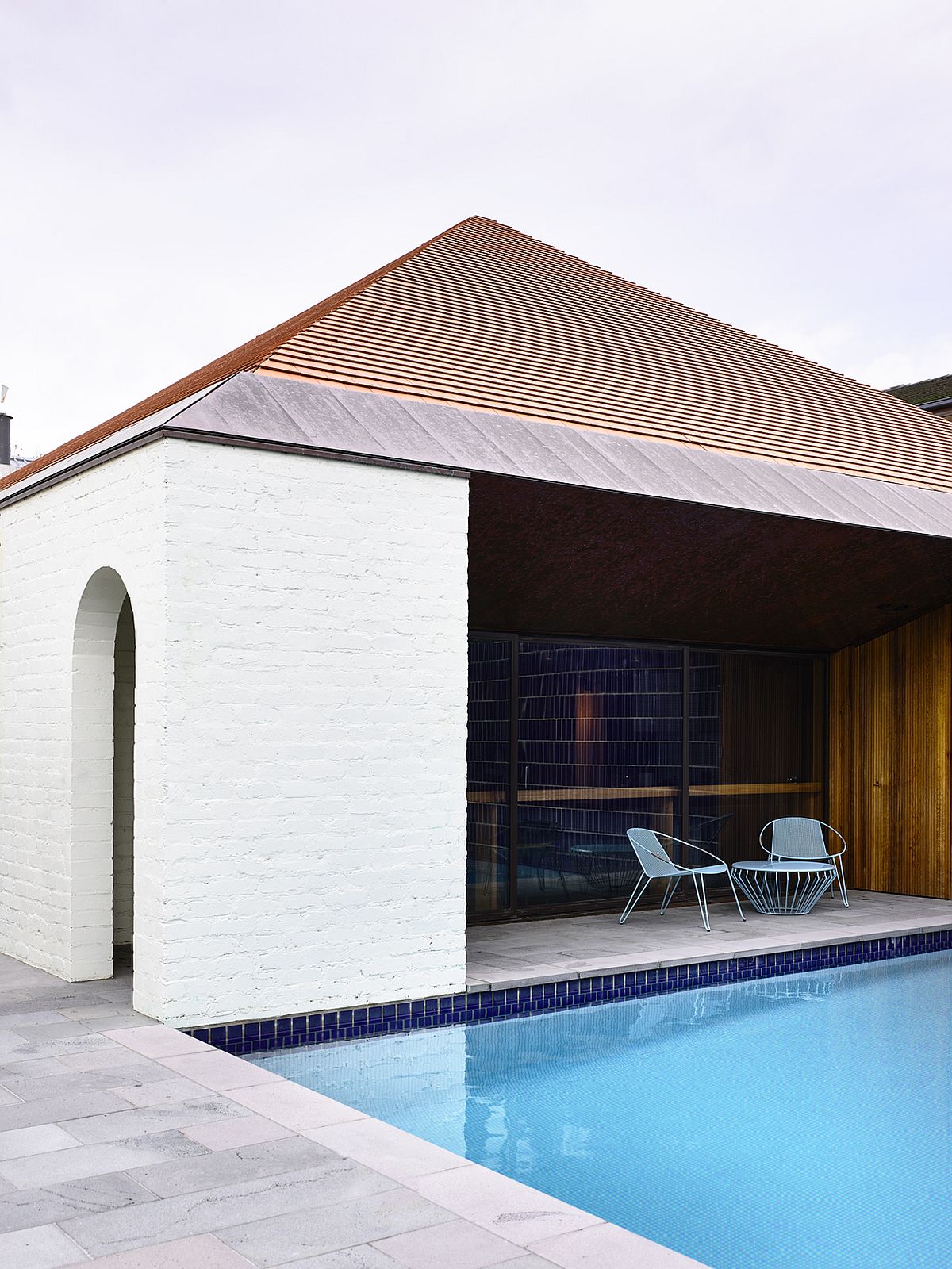 Shaded outdoor patio next to the pool