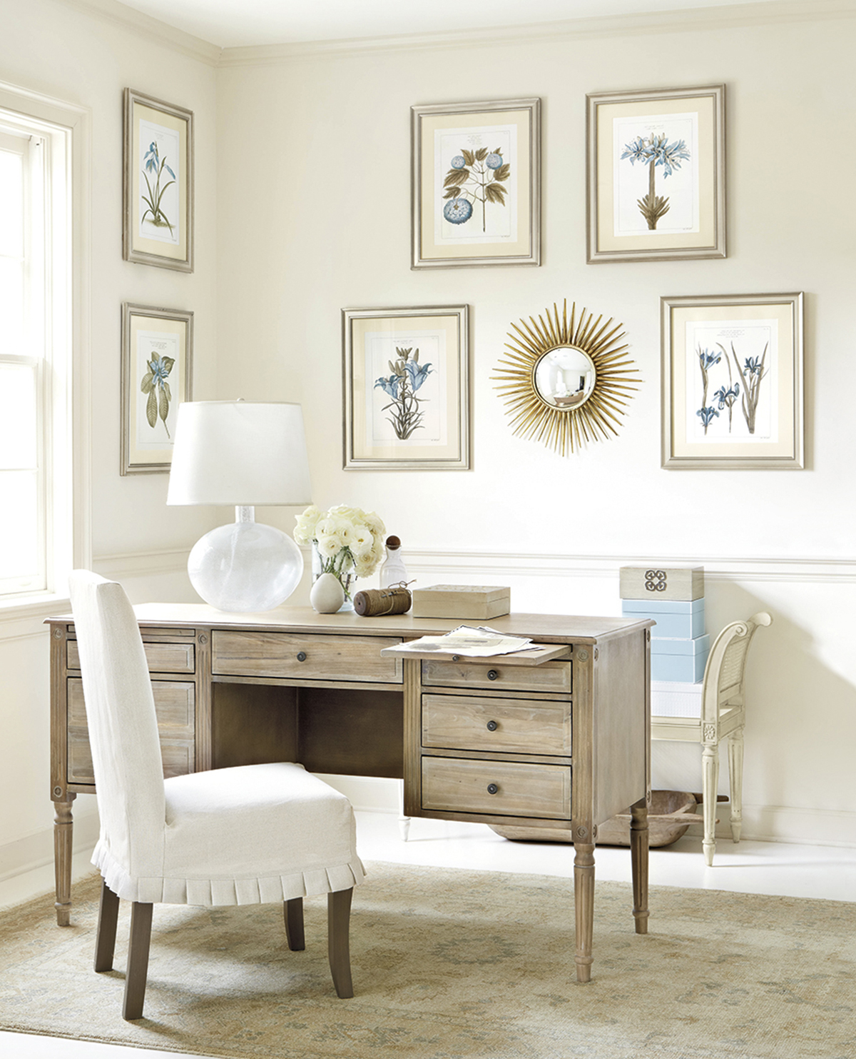 Small-sunburst-mirror-is-a-part-of-a-wall-gallery-in-a-serene-room