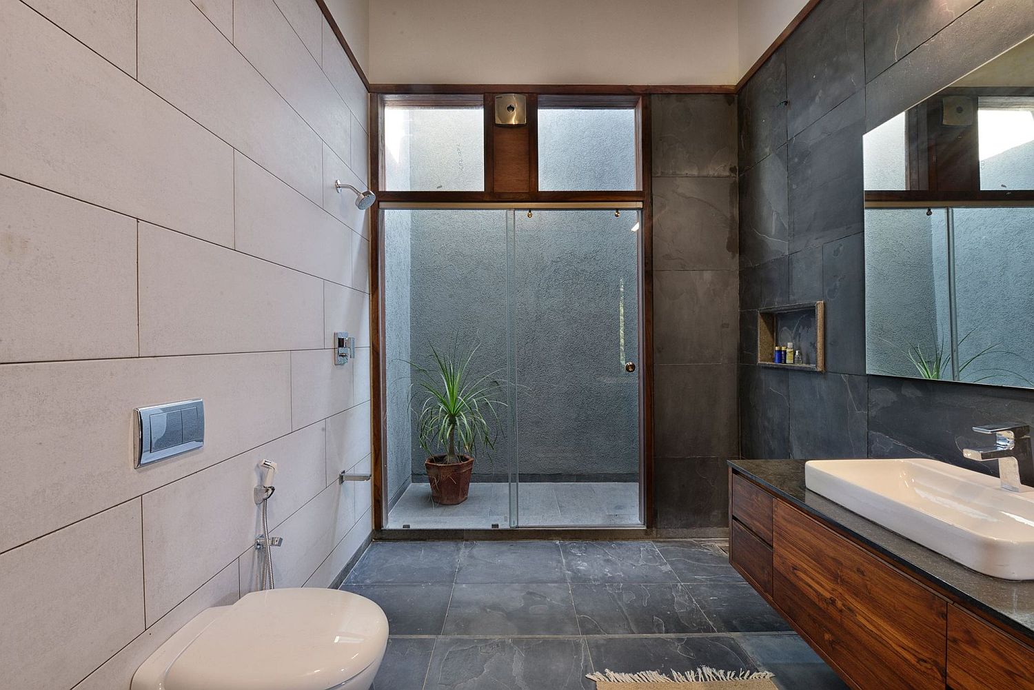 Smart modern bathroom in black and white with floating wooden vanity