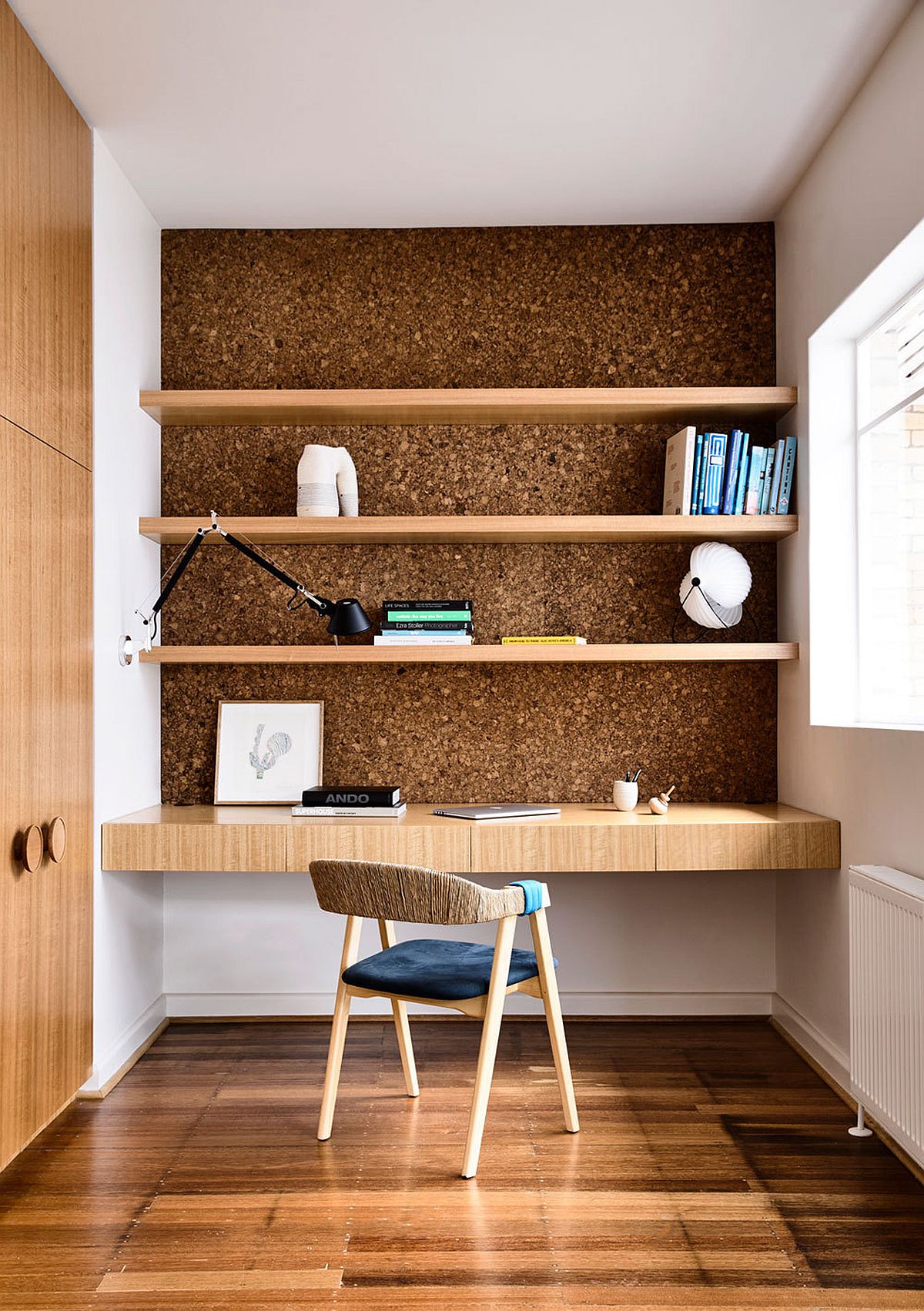 Space-savvy home workspace at the end of the hallway with floating shelves