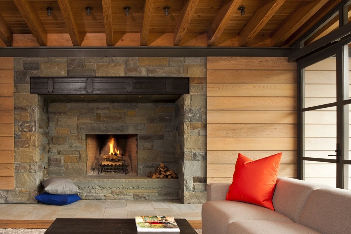 Traditional stone fireplace surrounded by wall with wooden slats