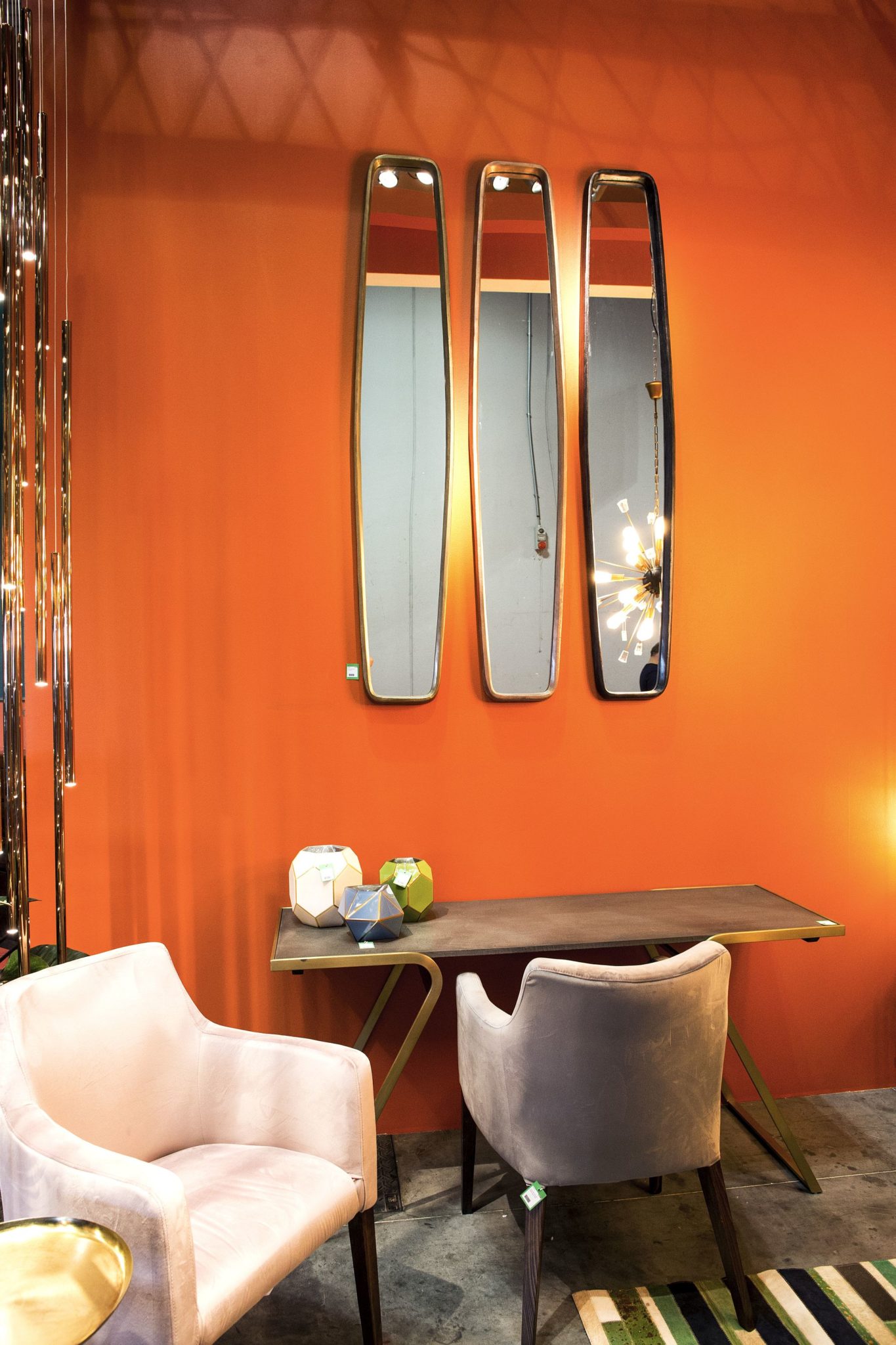 Trio-of-elongated-mirrors-with-a-dashing-backdrop-in-orange