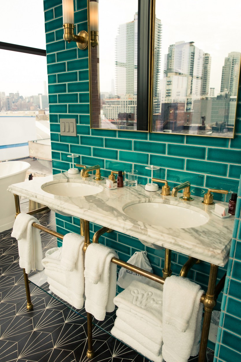 Turquoise bathroom with marble sink and golden pipes