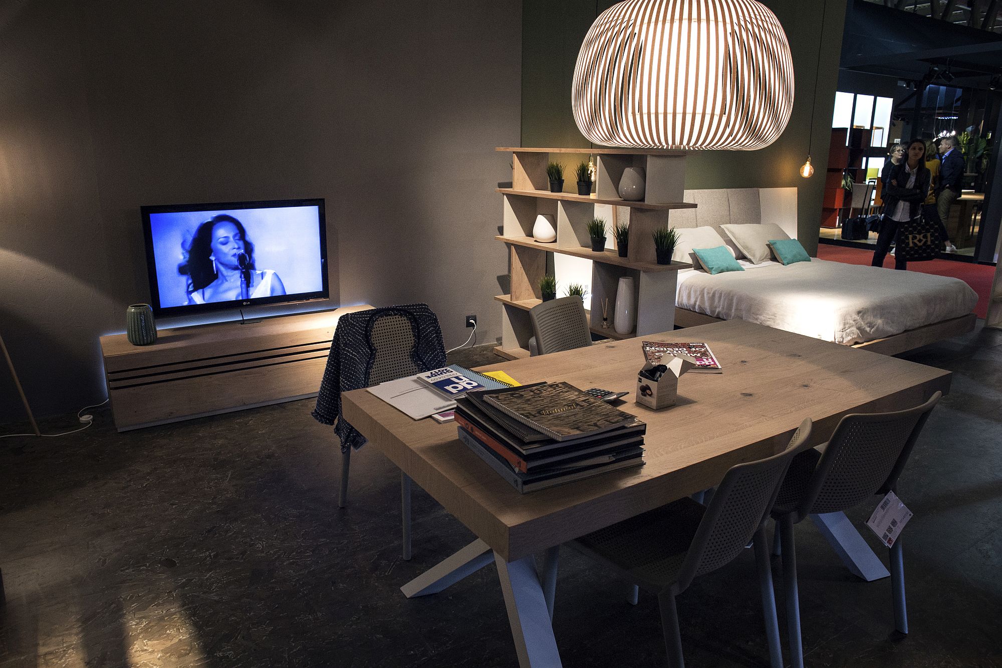 Understaded wooden shelf acts as a smart room divider in the tiny urban apartment