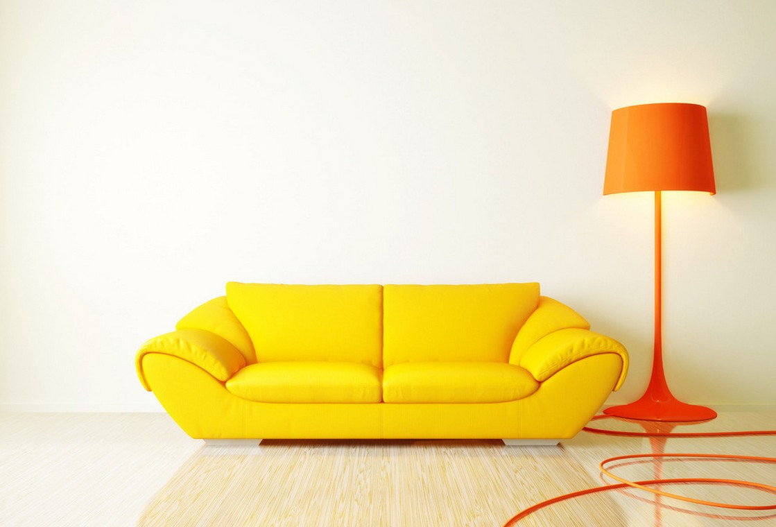 Vibrant yellow sofa and an orange lamp draw attention