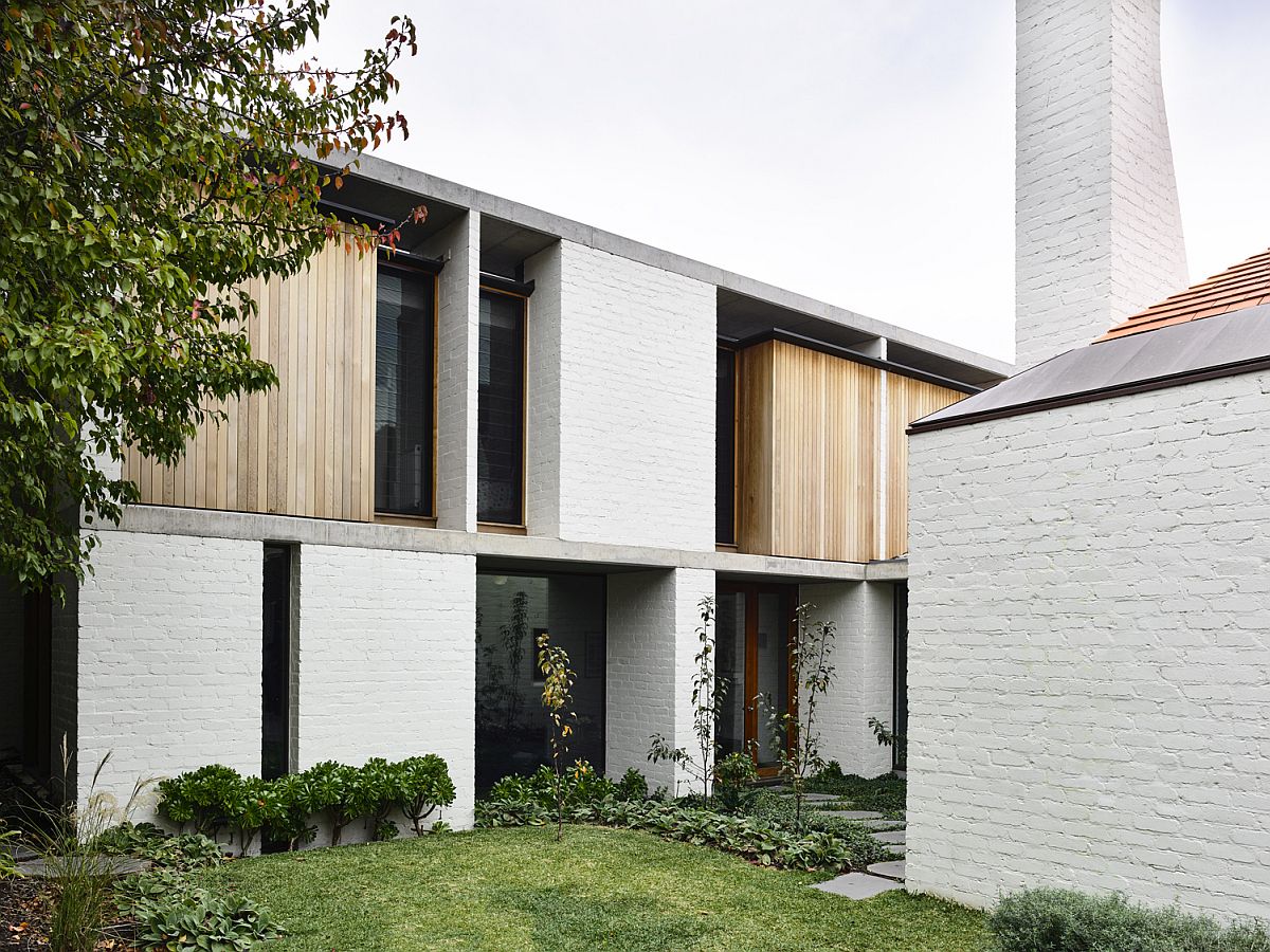 White brick exterior and chimneys give the home a classic vibe