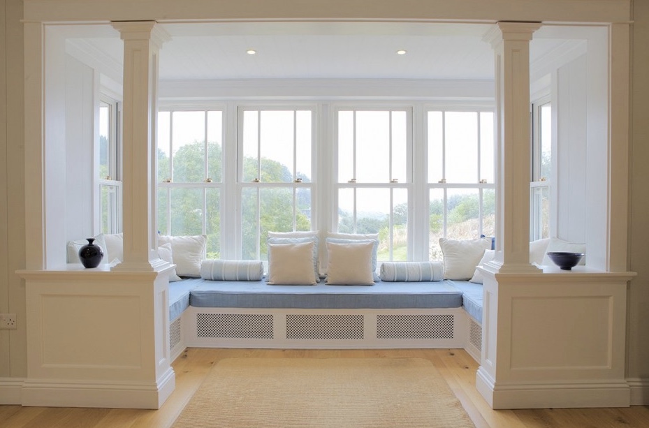 Window seat with a gentle color palette of white and soft blue