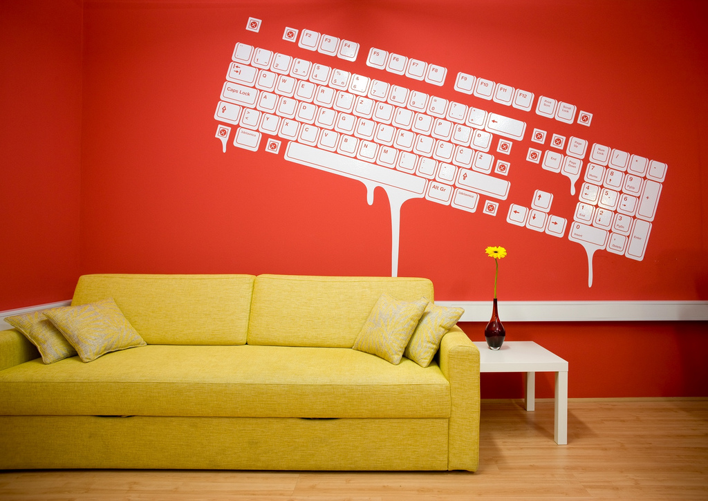 Yellow sofa and red background create a stylish interior