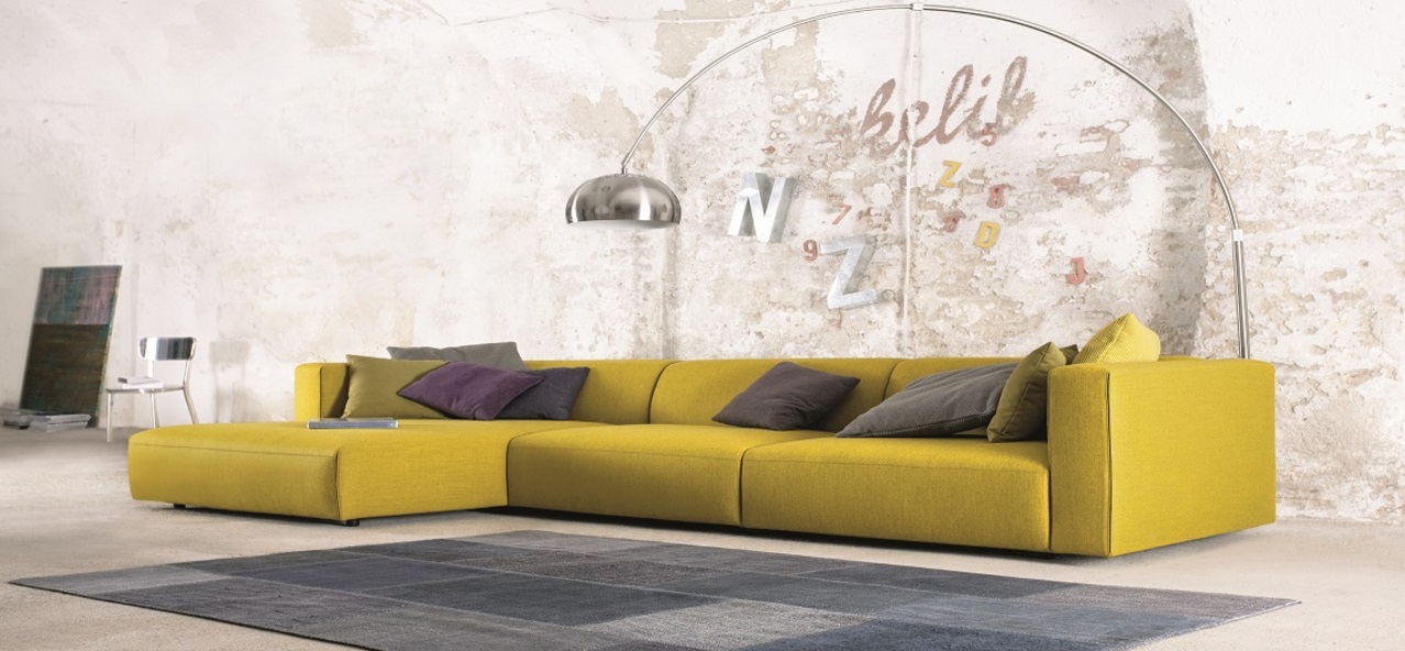 Yellow sofa stands out in an industrial room