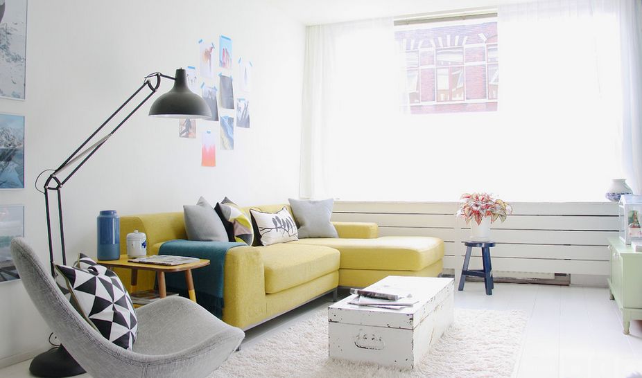 Yellow sofa uplifts the mood in a white living room