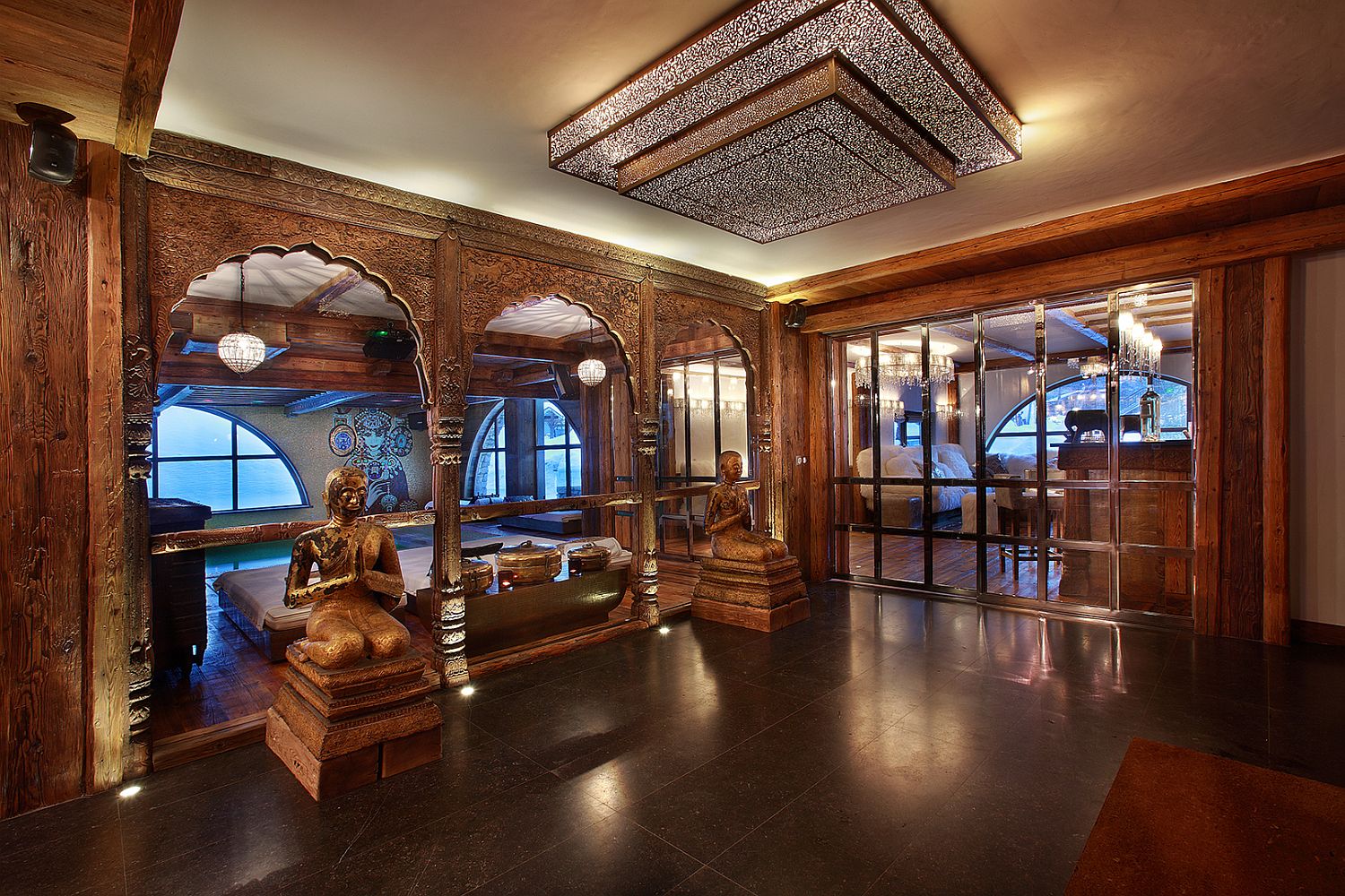 Asian ethnic motifs and carved wooden entryways at the luxury French chalet