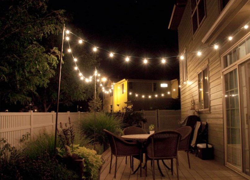 Backyard illuminated by string lights