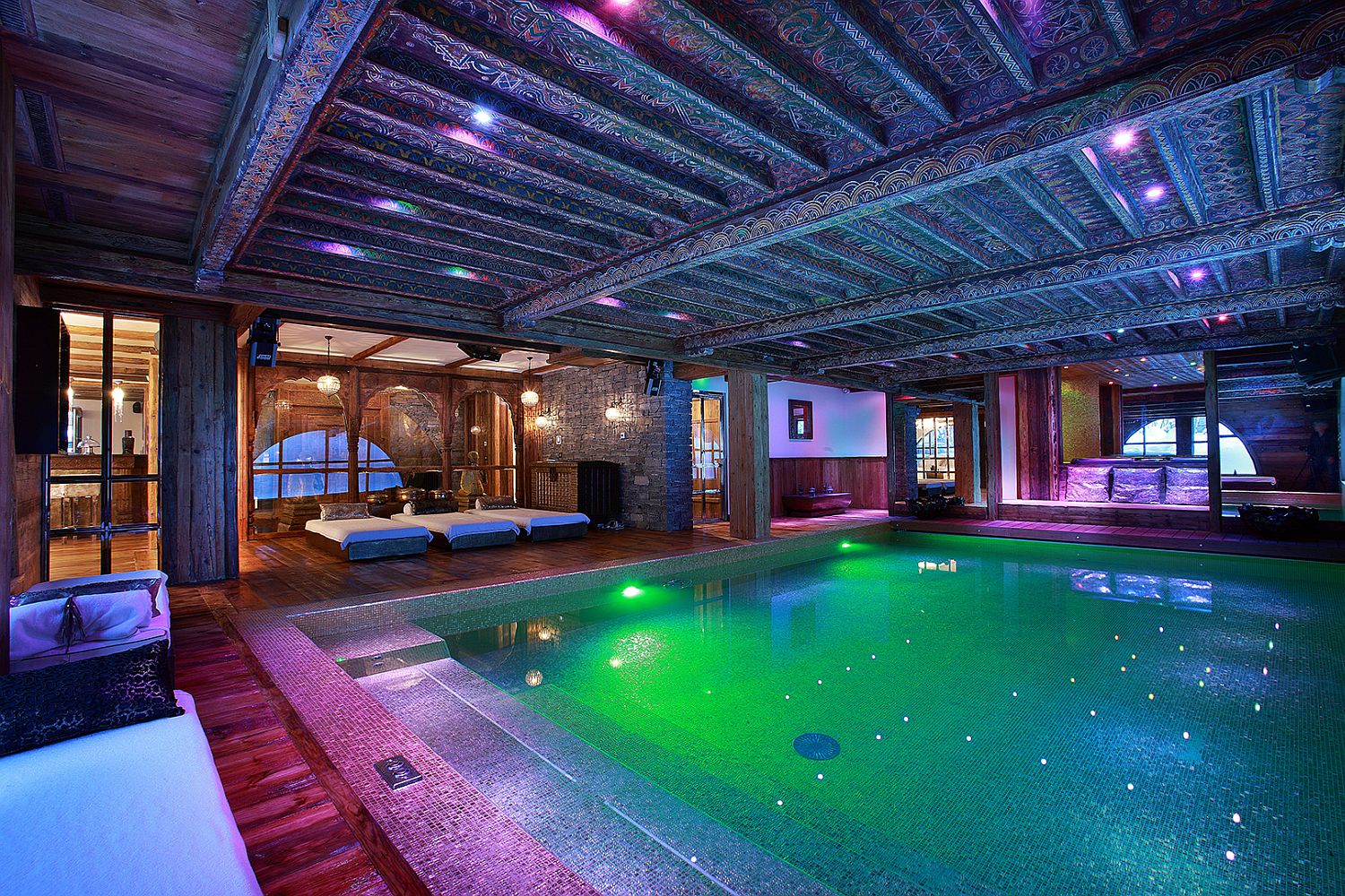 Beautifully-carved-wooden-beams-at-the-luxury-French-chalet-sit-in-contrast-to-contemporary-pool-space