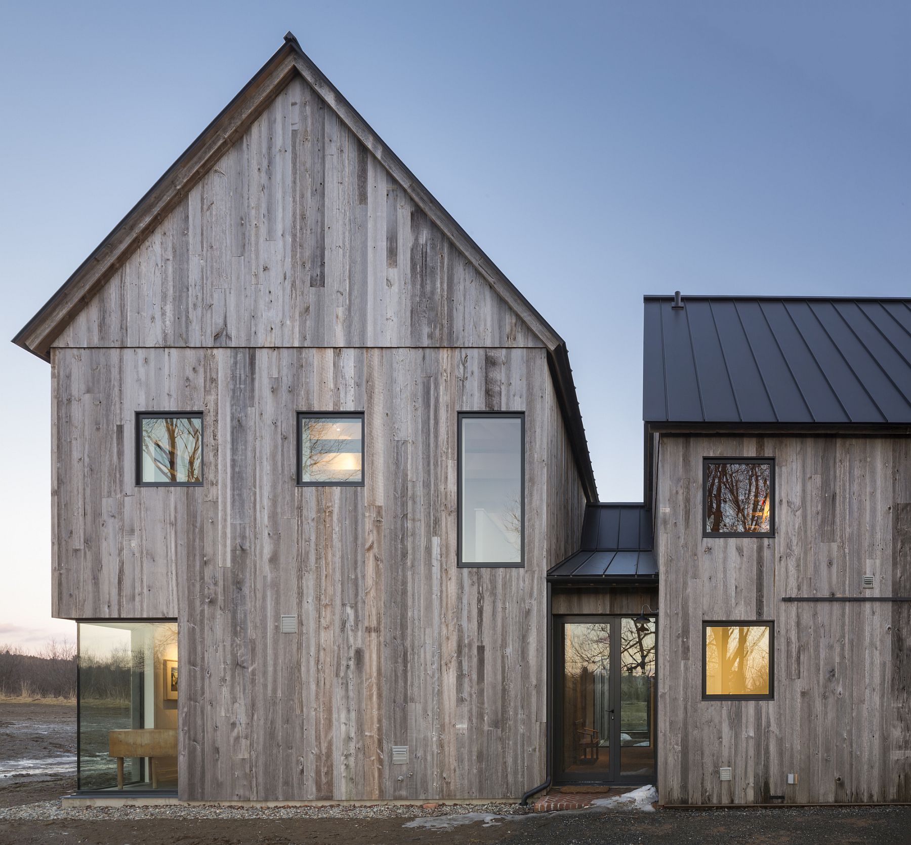 Beautifully framed windows add to the rustic exterior of the farmhouse