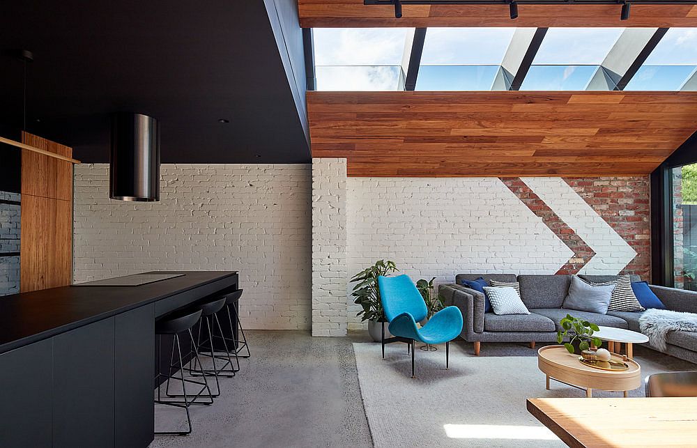 Black kitchen island and ceiling add drama to the interior