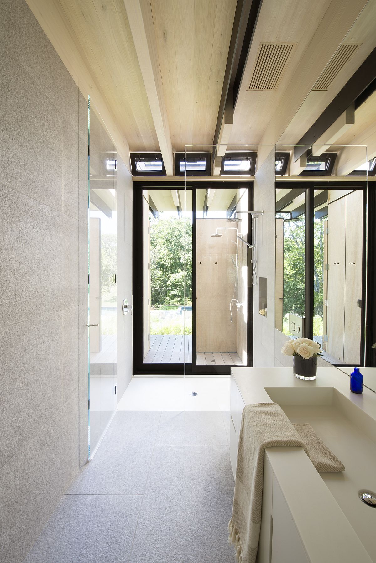Contemporary bathroom in white with large windows and black window frames