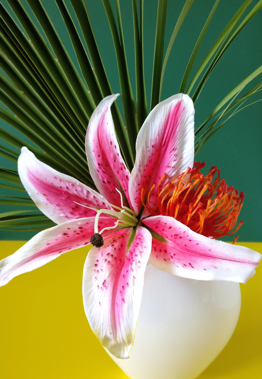 Create a tropical bouquet with greenery and flowers