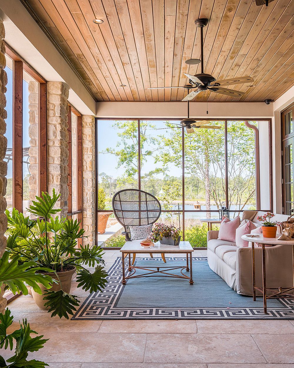 Fabulous beach style sunroom with plush couch and high-back chair