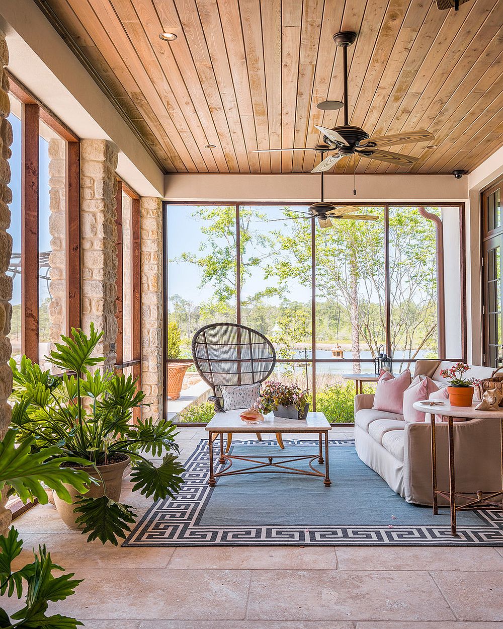 Fabulous-beach-style-sunroom-with-plush-couch-and-high-back-chair