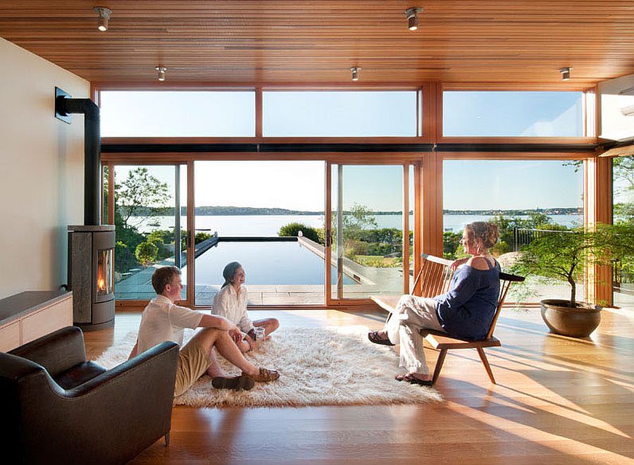 Fireplace in the corner adds to the charm of the minimal poolside pavilion