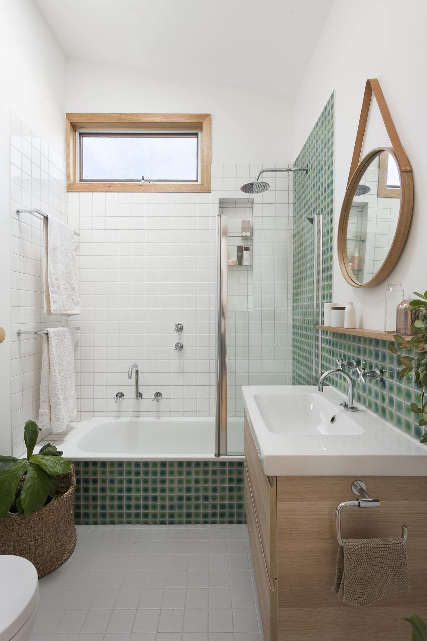 Floating-wooden-vanity-in-the-white-bathroom-with-mirror-that-adds-geo-style