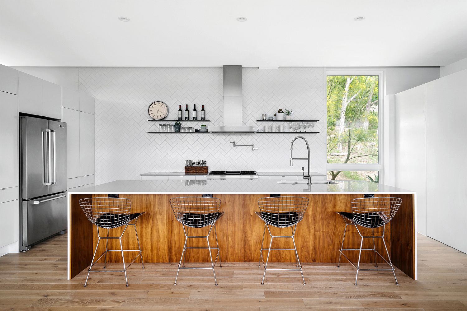 Herringbone pattern tiles create a beautiful backdrop in the kitchen with wooden island