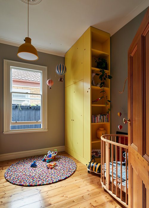 Kids-nursery-and-play-area-with-bright-yellow-shelf