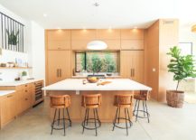 Kitchen-with-wooden-cabinets-and-a-square-island-that-also-serves-as-breakfast-zone-217x155