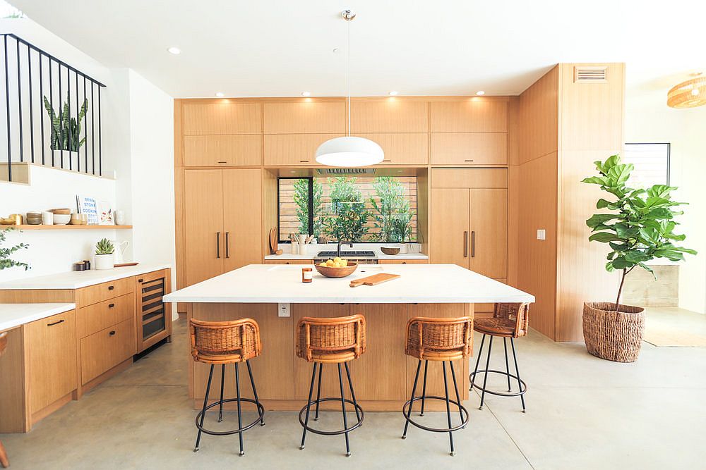 Kitchen with wooden cabinets and a square island that also serves as breakfast zone