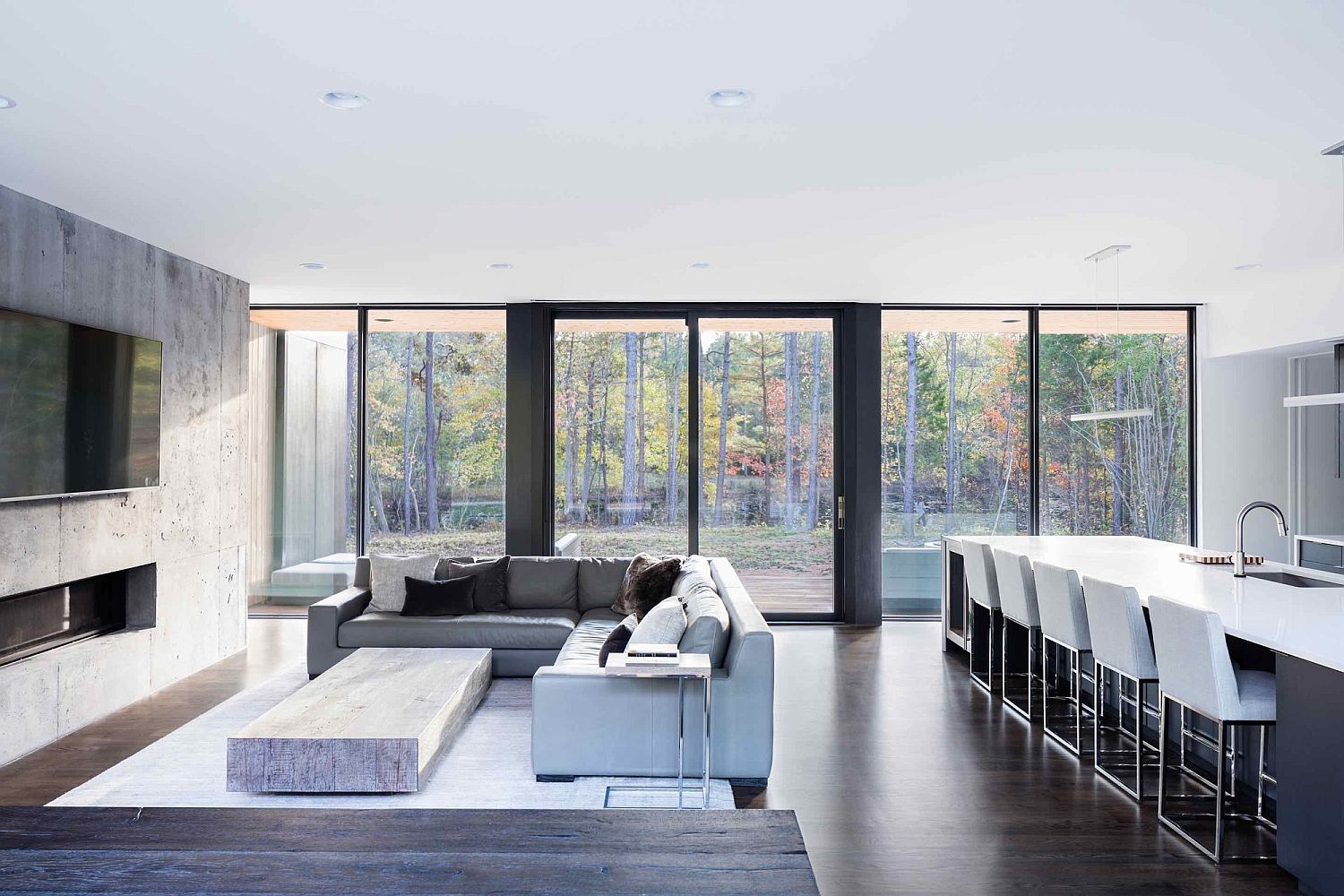 Large glass doors and windows connect the minimal interior with view outside