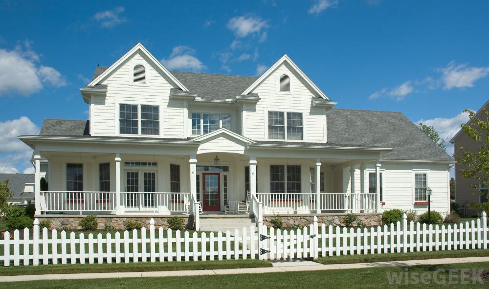 Large house with a low white picket fence