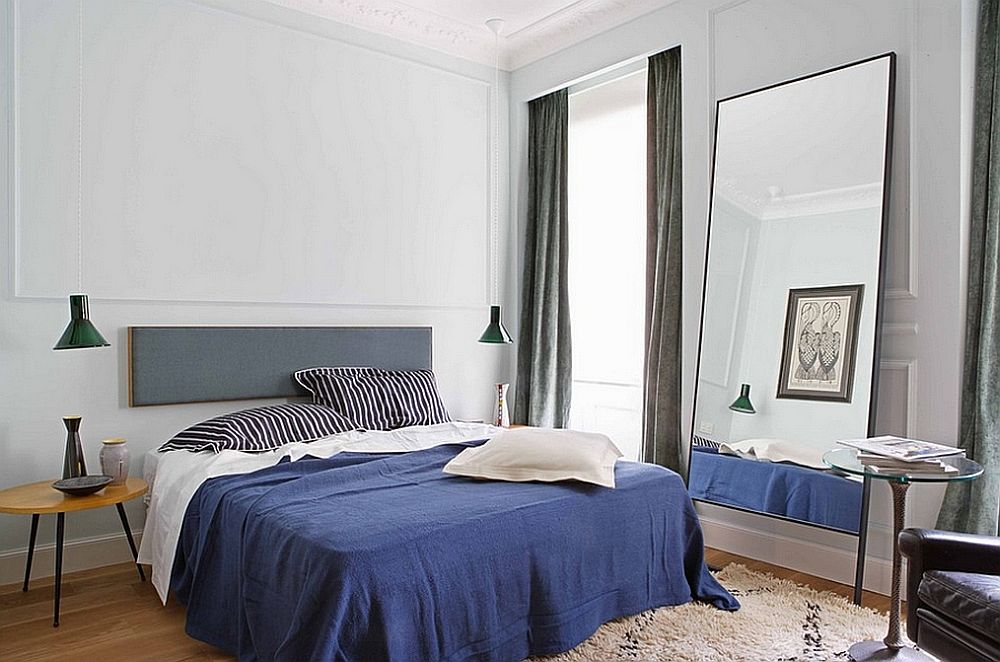 Light gray replaces white in this masculine bedroom with hints of blue