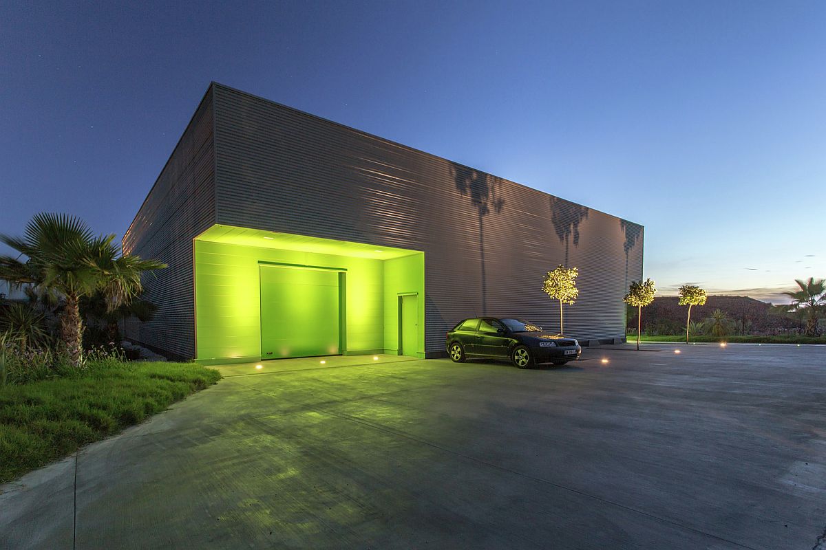 Lighting highlights the green entrance of the office