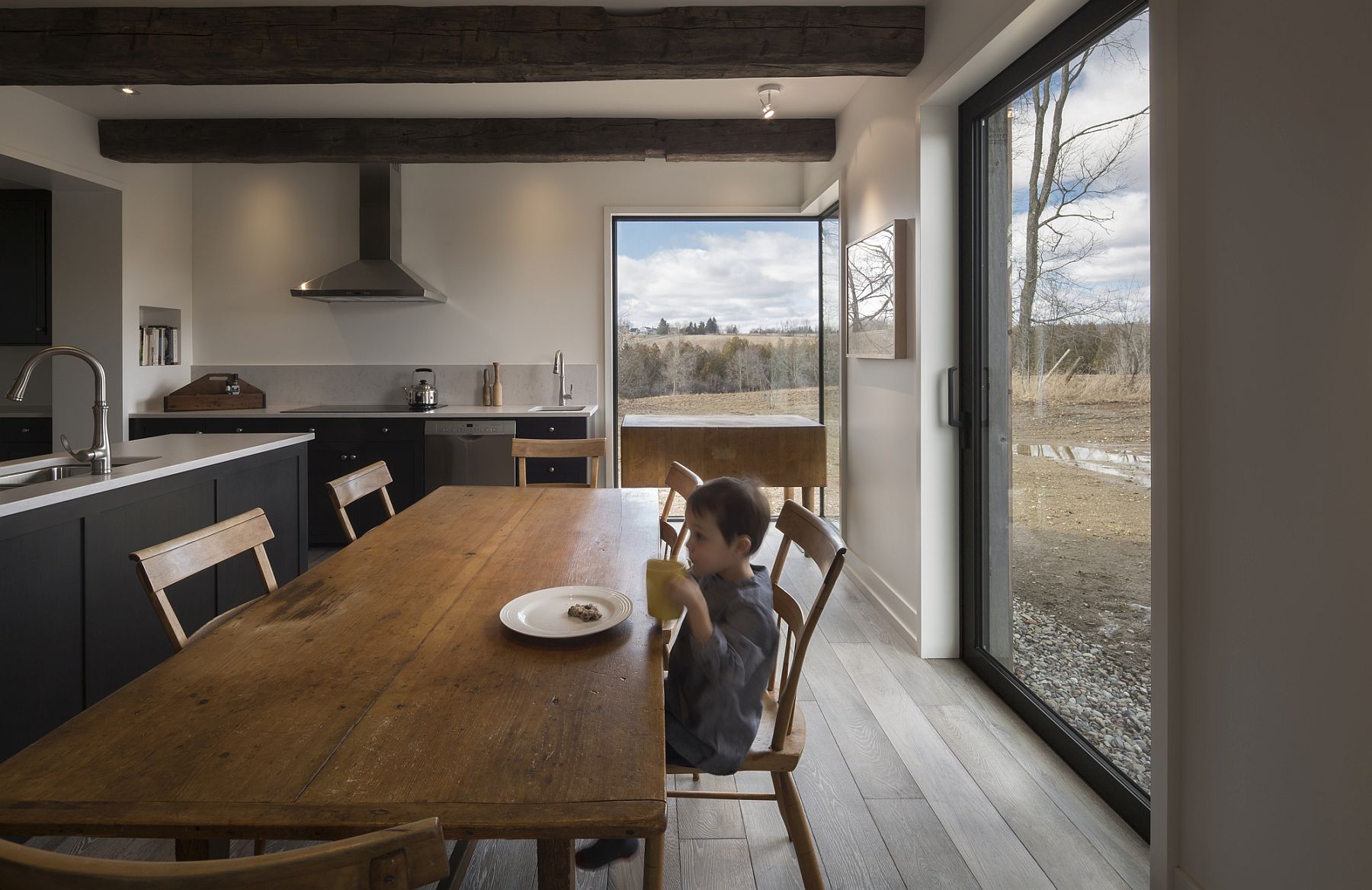 Modern dining room and kitchen of the farmhouse with framed views