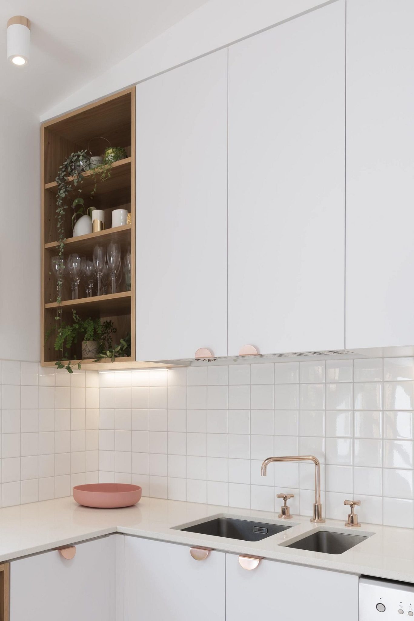 Open kitchen shelf in the corner along with closed cabinets in white