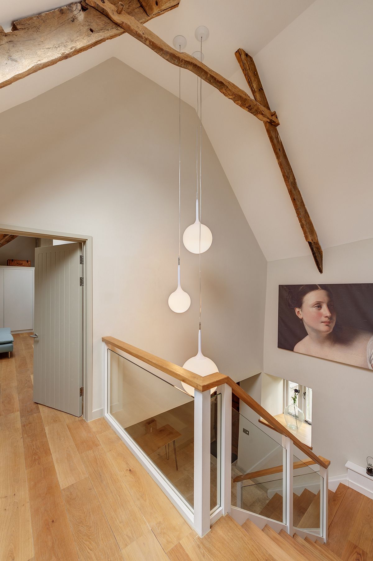 Pendant lights illuminate the lovely stairwell