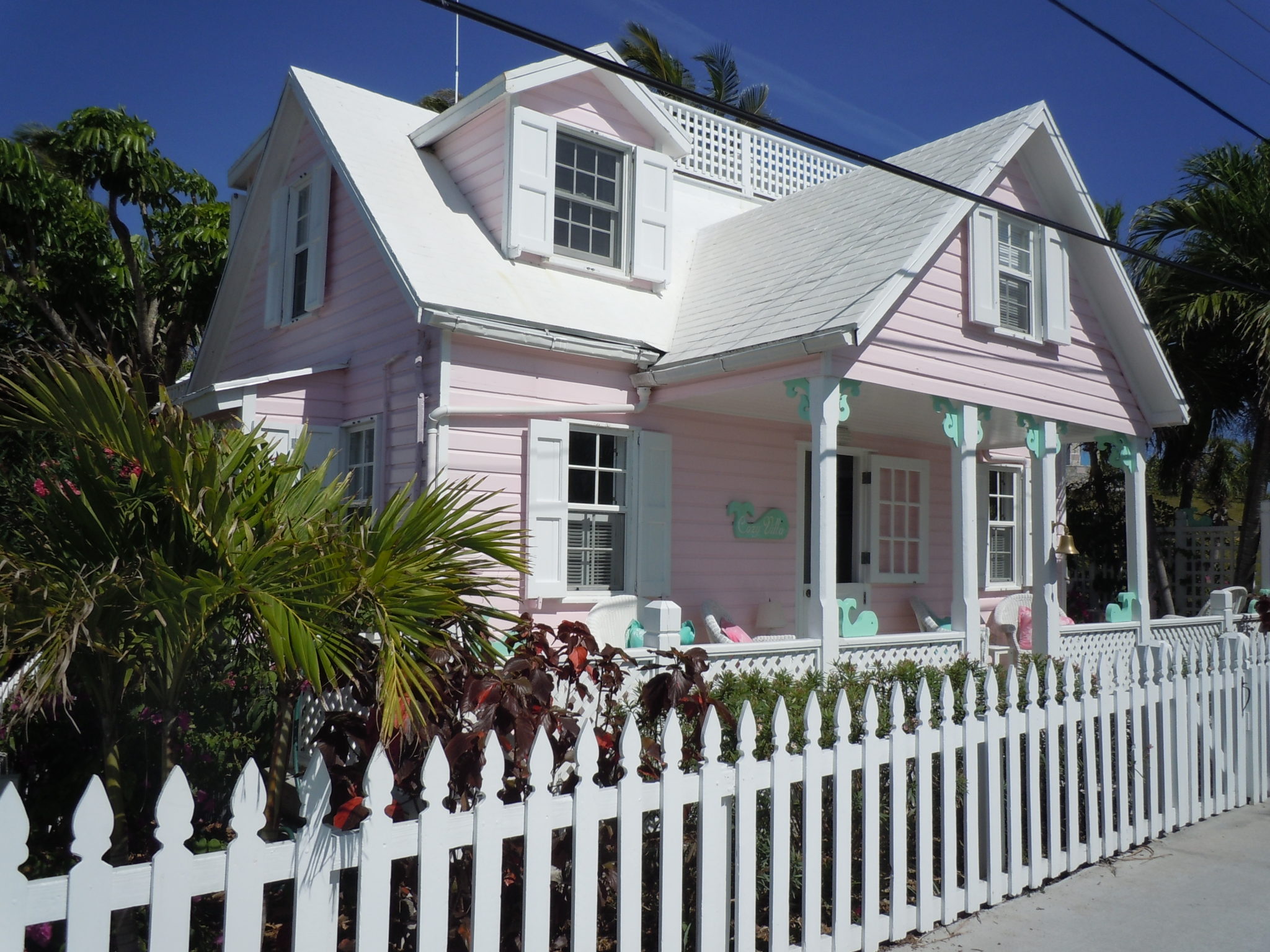 Pink retro house with a white picket fence