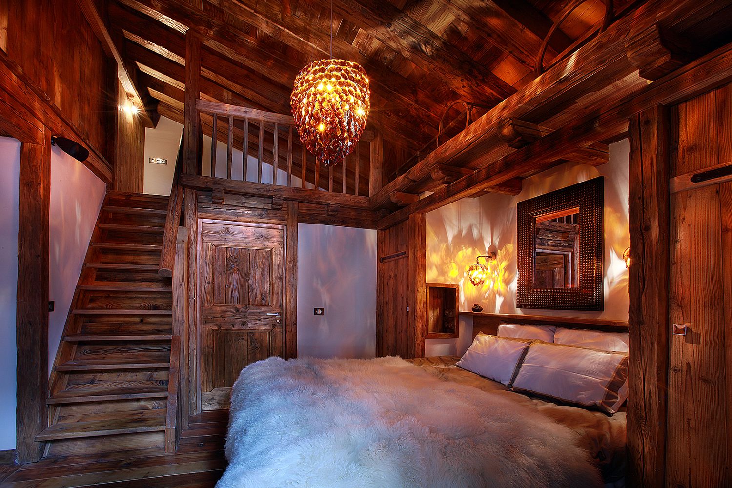 Plush textures add to the inviting charm of the chalet bedroom