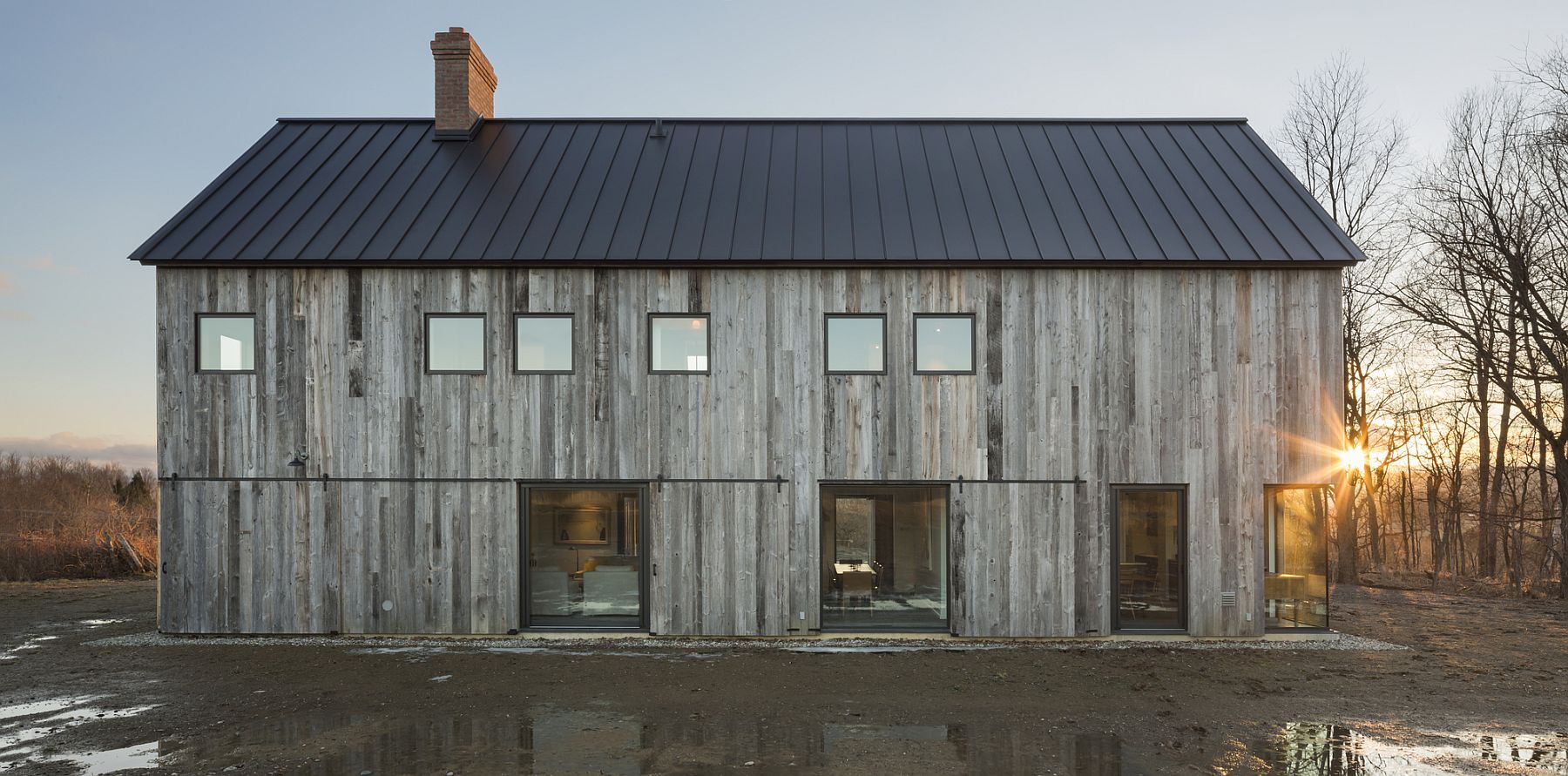 Rustic agricultural landscape and rolling hills surround the lovely farmhouse