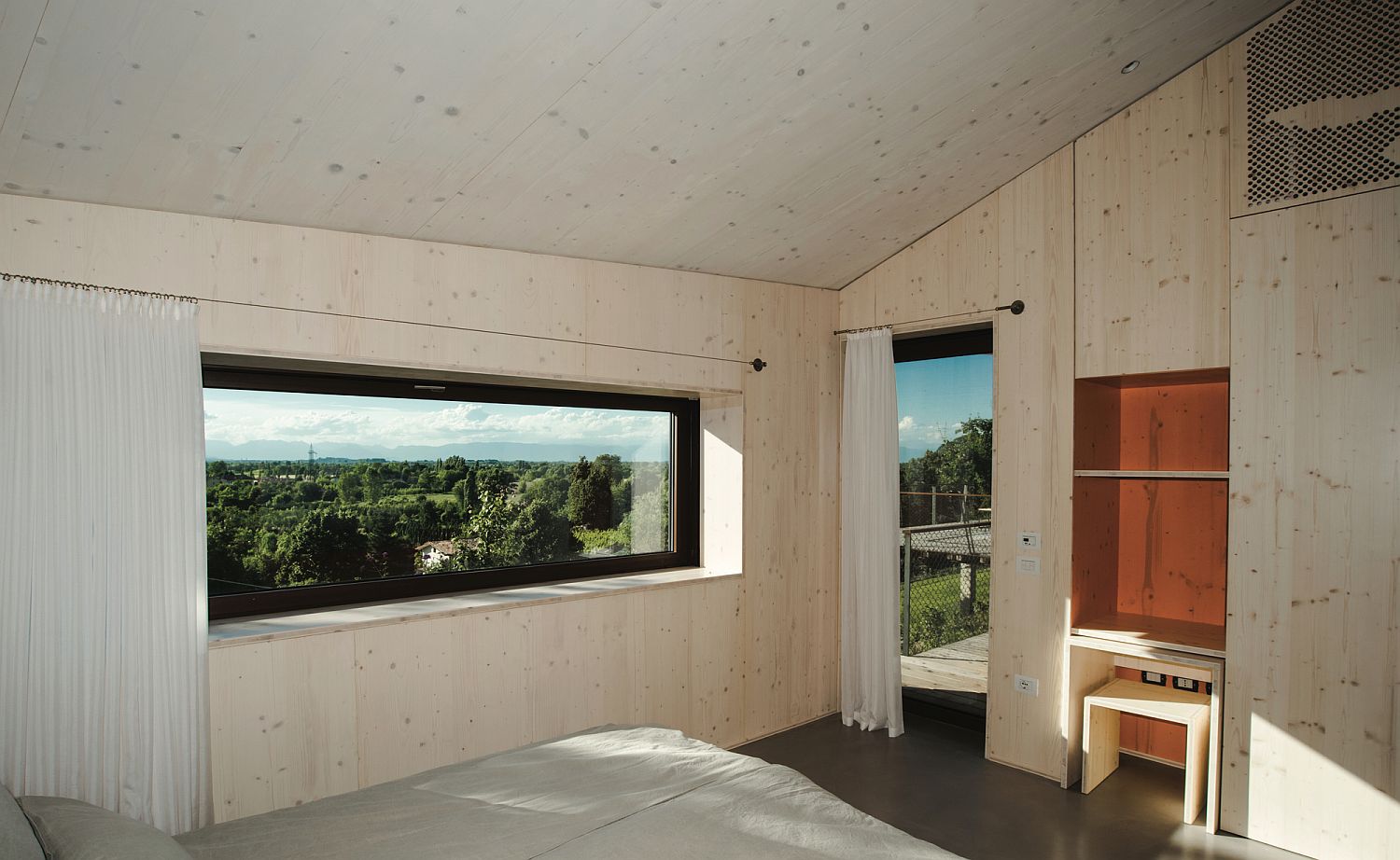 Simple and minimal bedroom with walls draped in wood