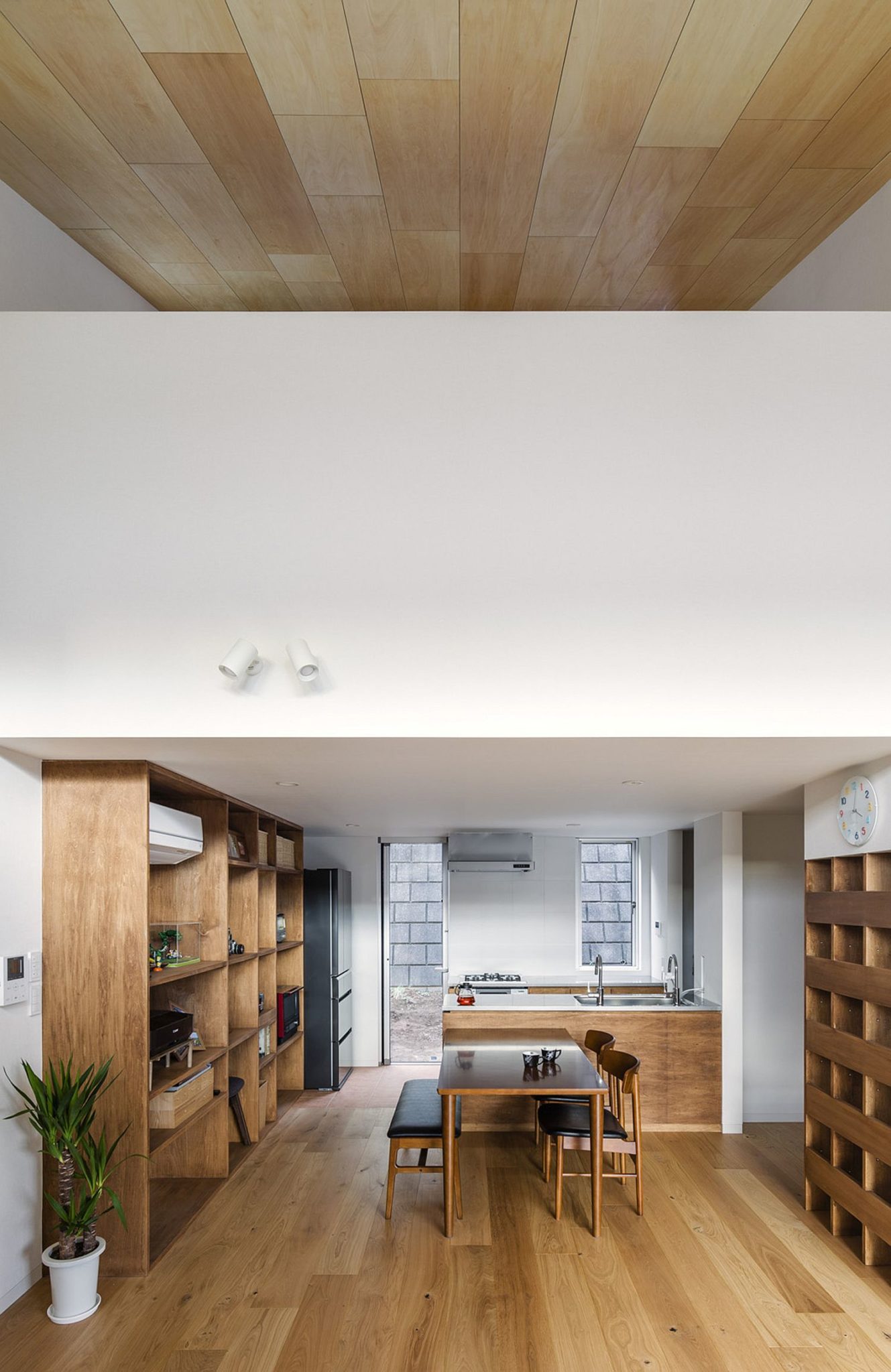 Slanted ceiling and double-height living room of the Japanese home