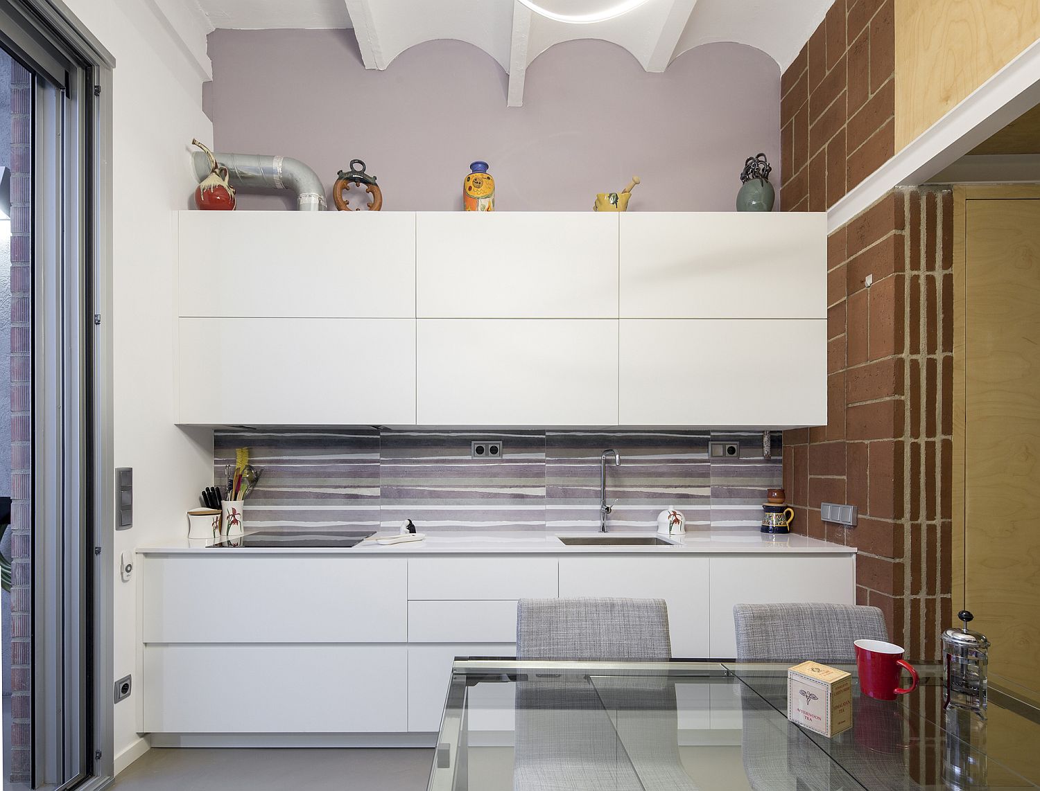 Small contemporary kitchen in white with sleek shelving