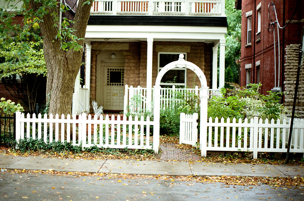 Small town house with a white picket fence