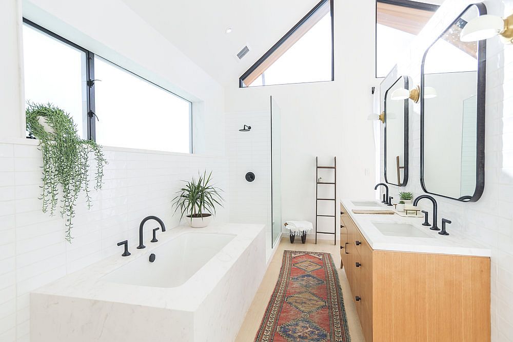 Spacious bathroom in white with wooden vanity and twin sinks