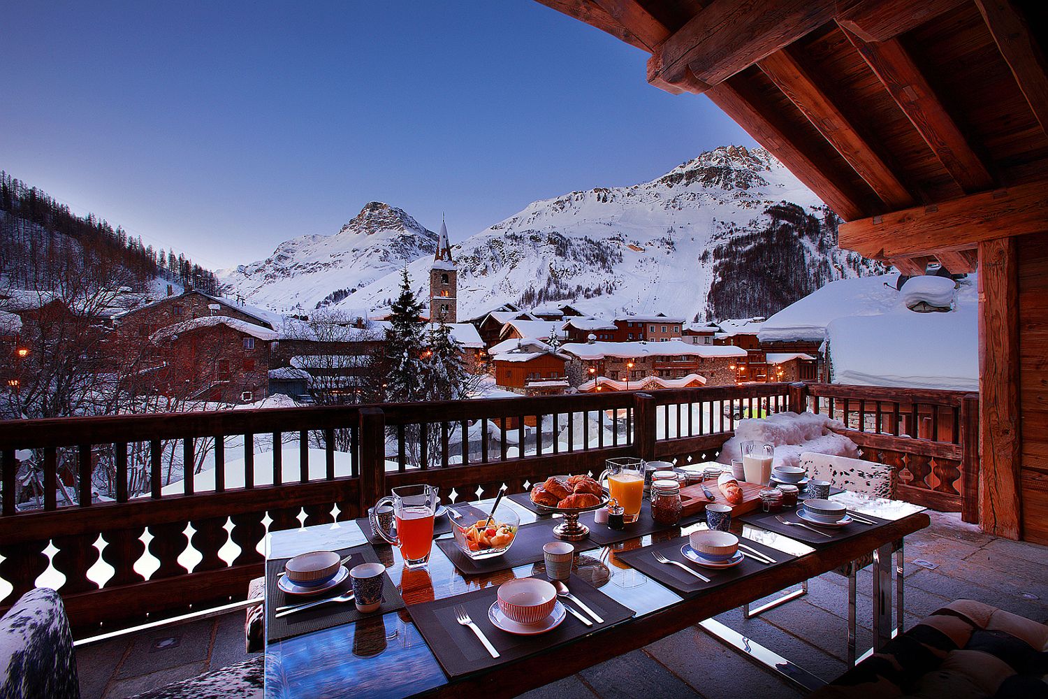 Stunning snow-covered peaks and quiet landscape viewed from the balcony of the luxury chalet