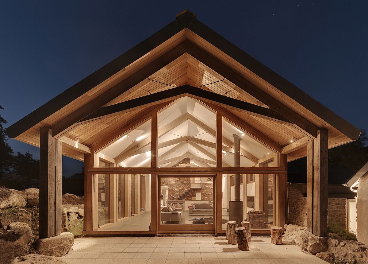 Timber and glass structure sits next to the original stone walled farmstead