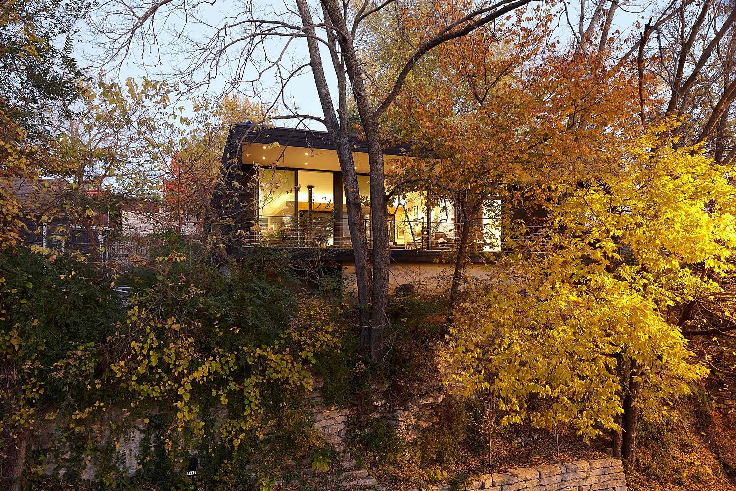 Trees and a curated garden carefully hide the house from street view