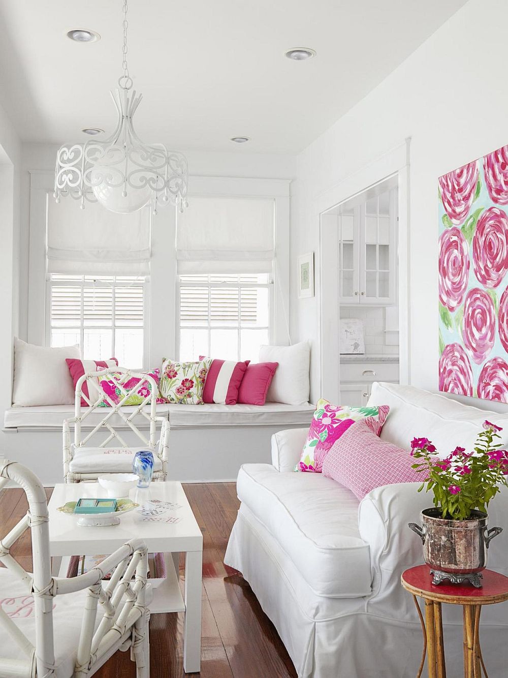 White and pink sunroom with plush seating