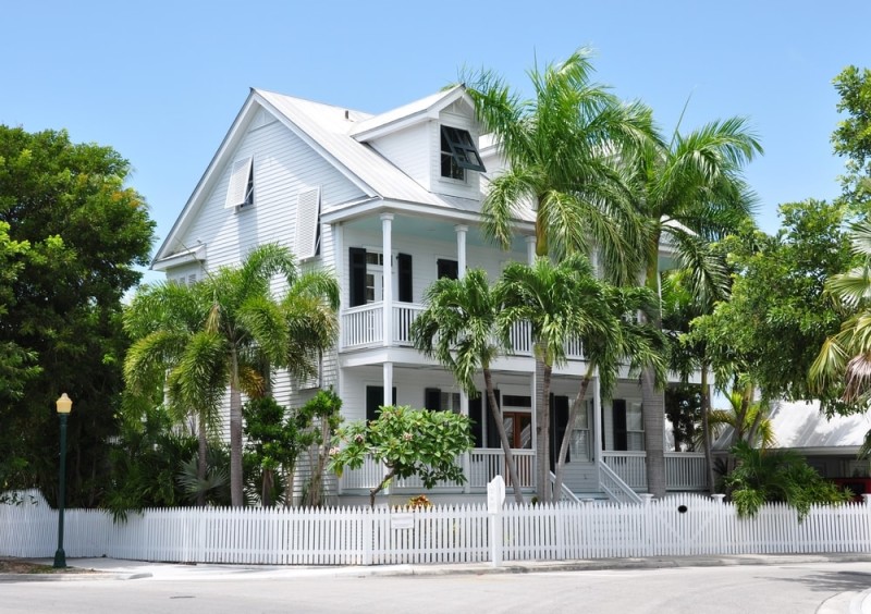 White picket fence contrasting the surrounding greenery