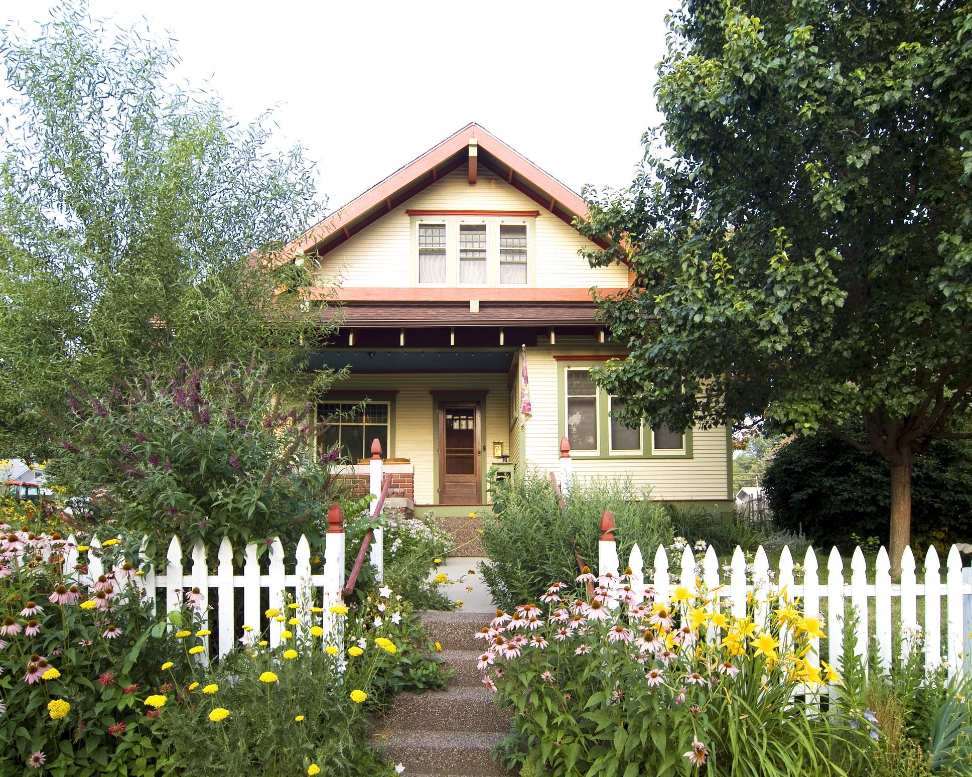 White picket fence hidden among the flowers